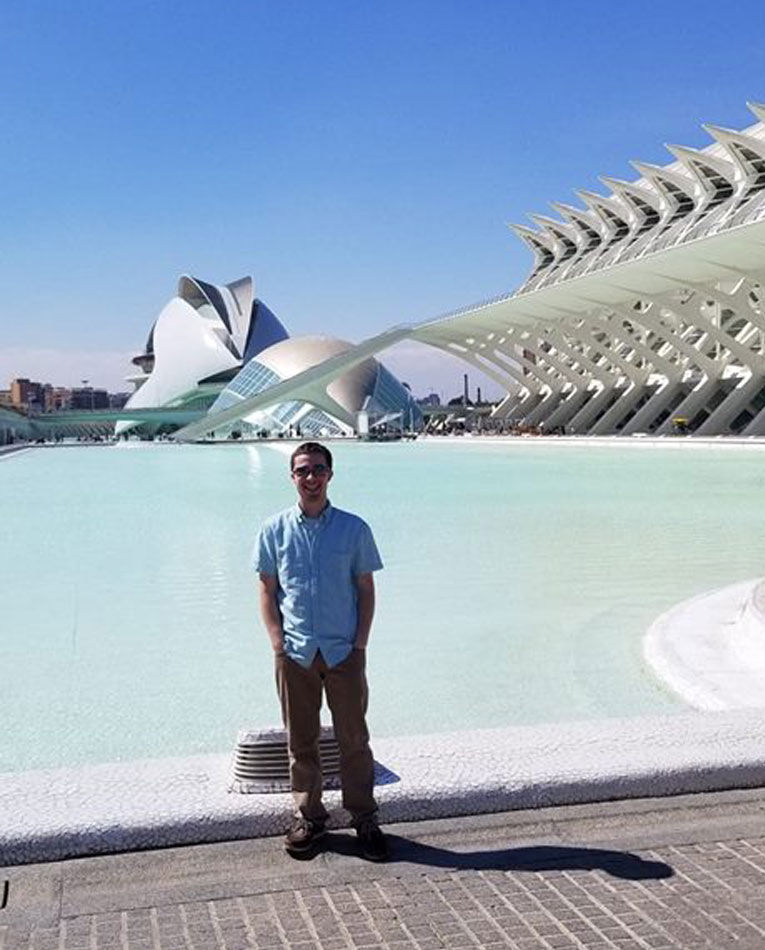 Man standing in front of water before the City of Arts and Sciences