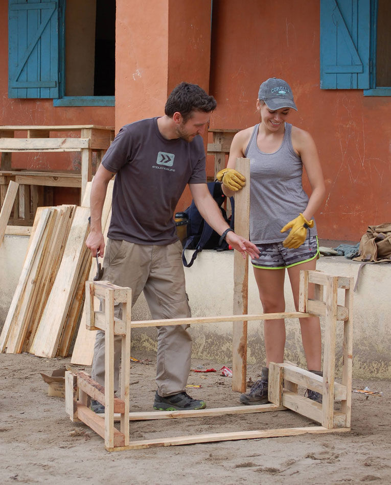 Man and women helping build a desk