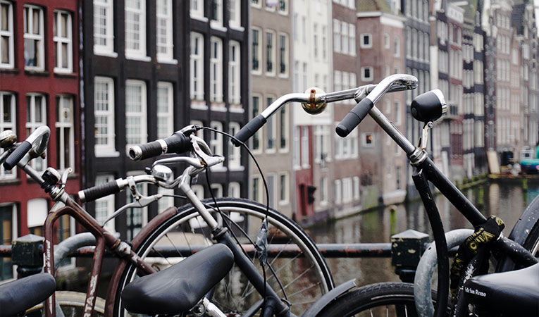 Bicycles parked along a canal in Amsterdam