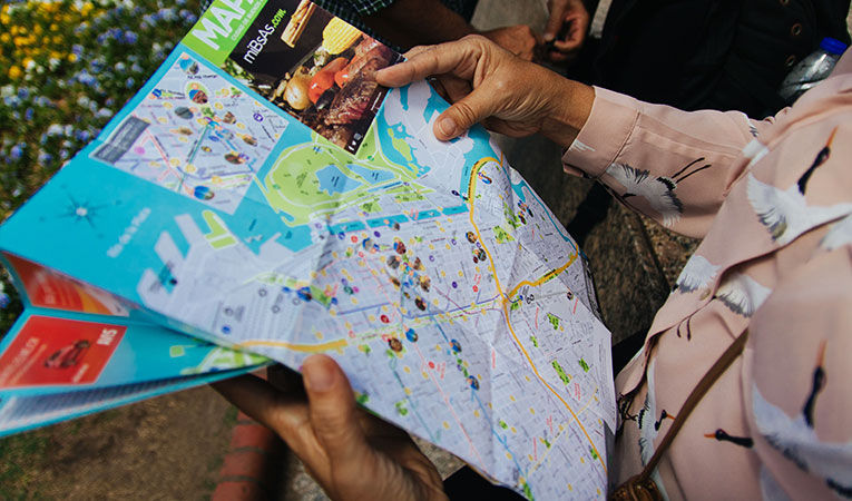 Girl reading map in south america