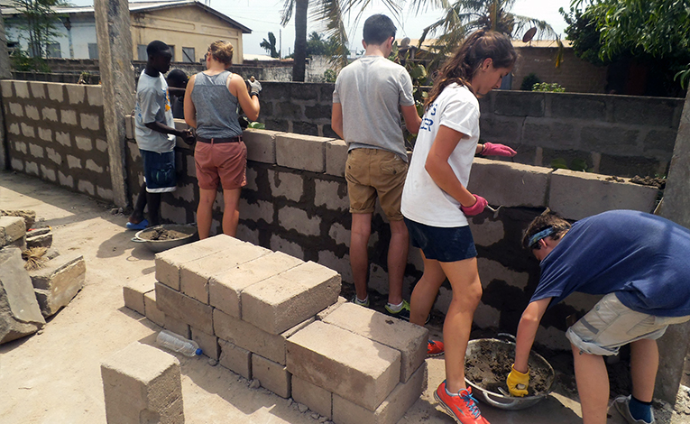Construction volunteers building a wall