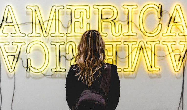 woman looking at america sign