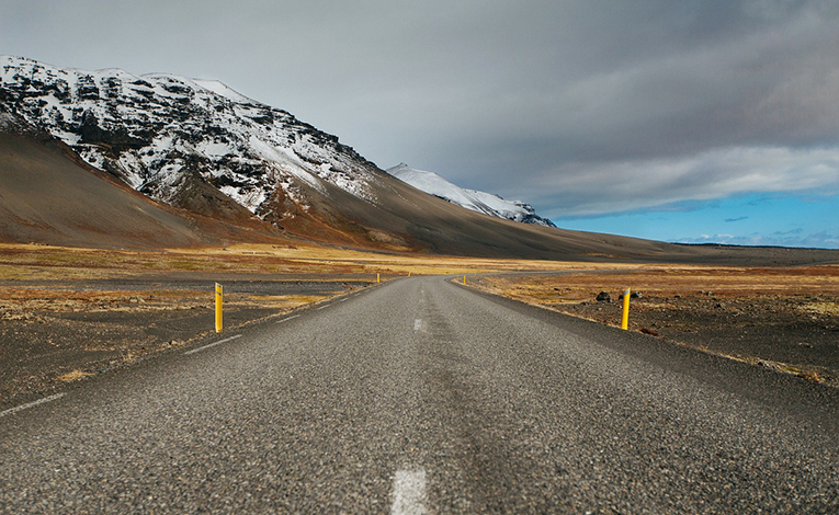Road next to snow covered mountains