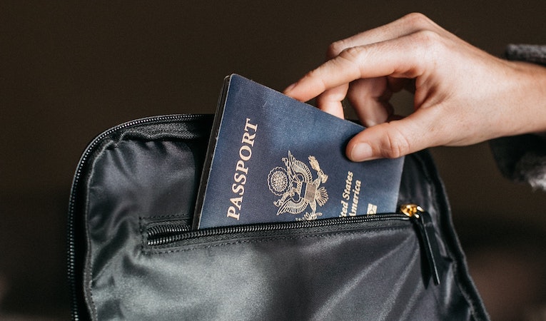 person sliding their passport into a pocket
