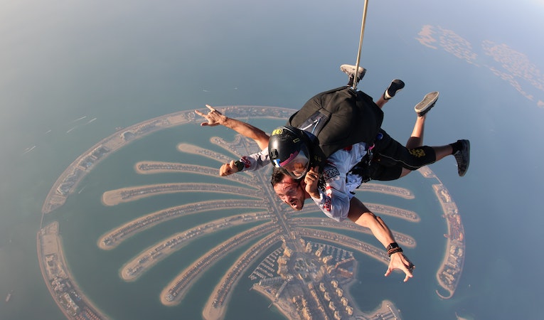 two people skydiving over dubai